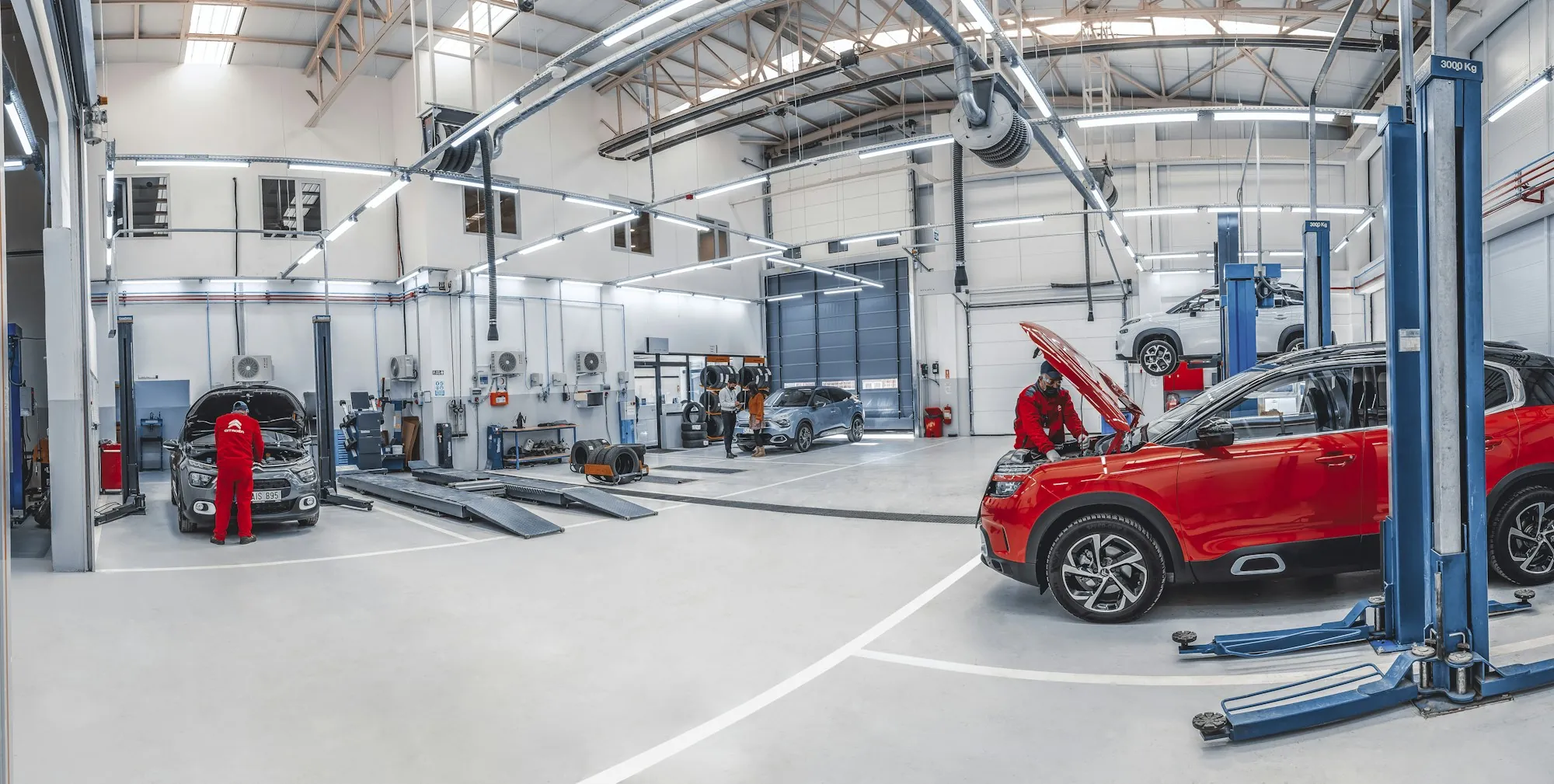 Bright, organized repair shop with vehicles on lifts